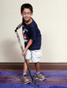Ali using his hockey device which was funded thanks to public support of the Key Tag Service.
